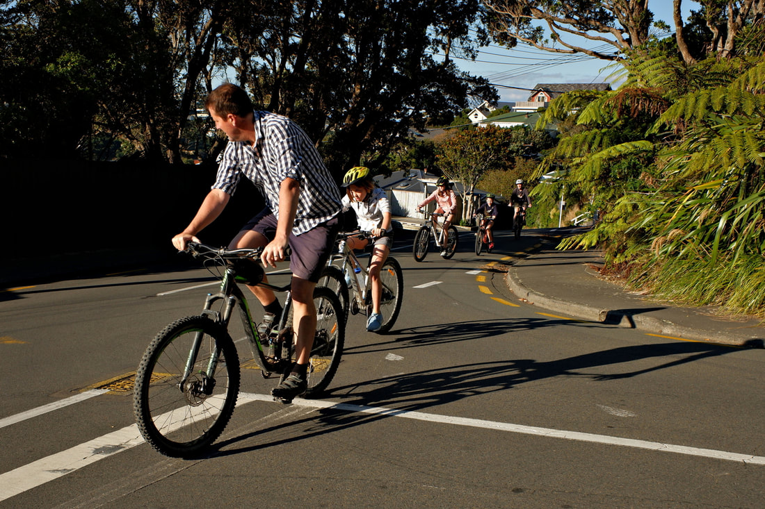 Reg Feuz- Wot!  No Helmet Dude leads his bicycle train through Wadestown, Mairangi Road. Wellington, New Zealand, photography during the covid-19 lockdown in New Zealnd, Photospace Gallery contemporary New Zealand photography wellington nz, a month of sundays online exhibition