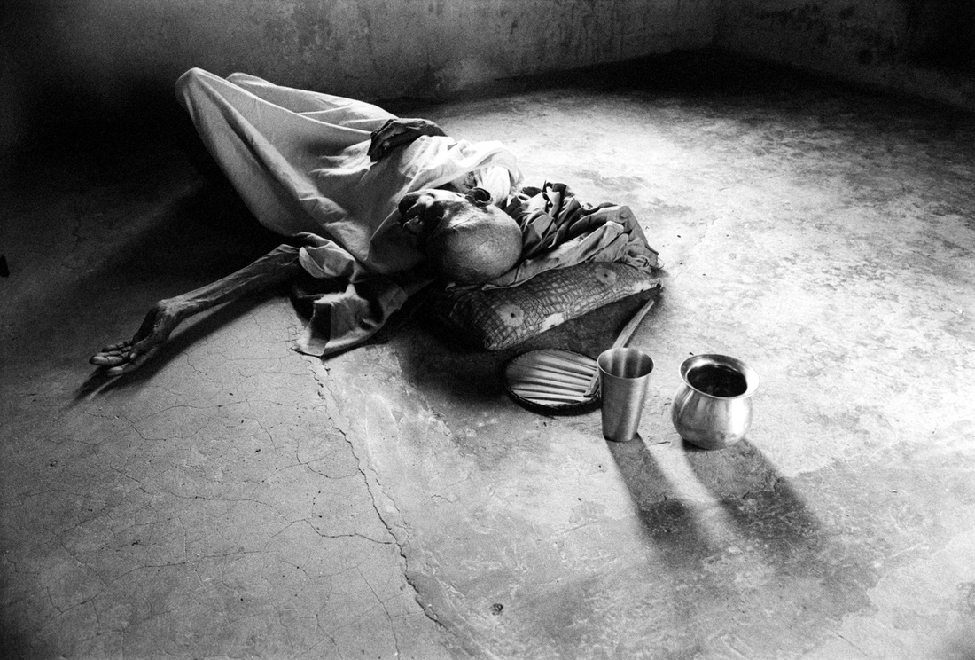 A pilgrim lies on the floor at the Kashi Labh Muktibhavan, Varanasi, India, 2001, Photo by John Williams, from 'Pilgrimage', Photospace Gallery Wellington NZ 2016