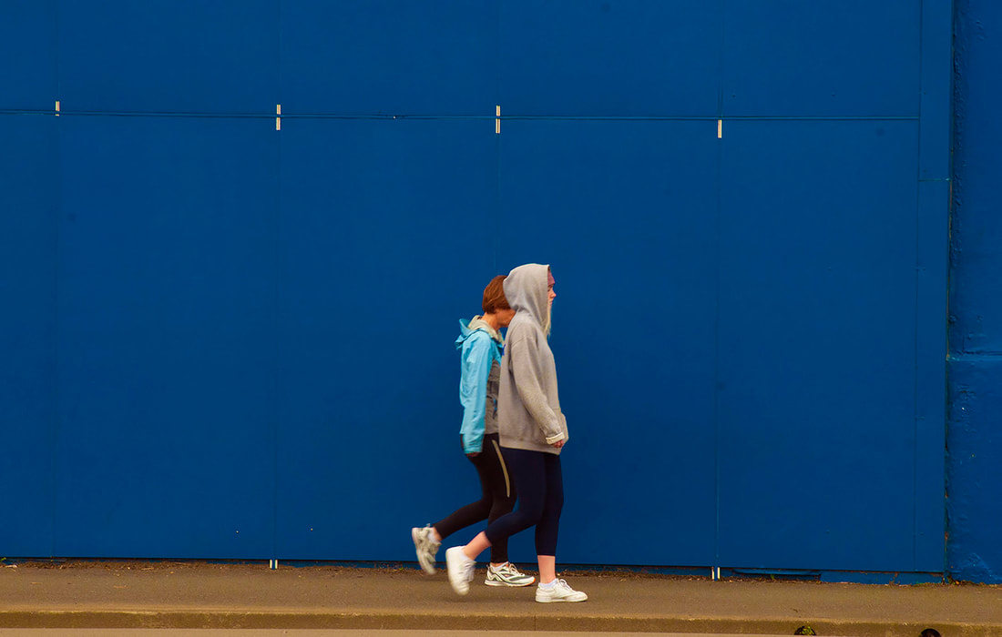 Max Oettli - 'Azurra, Thorndon Quay', April-May 2020, Photospace Gallery contemporary New Zealand photography, Wellington NZ, online exhibition covid-19 responses by new zealand photographic artists, tabletop photography, conceptual photography, girls walking past blue wall