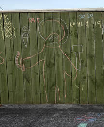 lhs detail of Dan Anbury - Untitled (Fence, Levin), April 2020, Photospace Gallery online exhibition A Month of Sundays - Responses to the Covid-19 lockdown, photographic artists respond to the lockdown in New Zealand, Contemporary New Zealand Photography gallery in Courtenay Place Wellington, children's chalk graffiti writing on fence in Levin Horowhenua during Covid-19 lockdown in New Zealand 2020