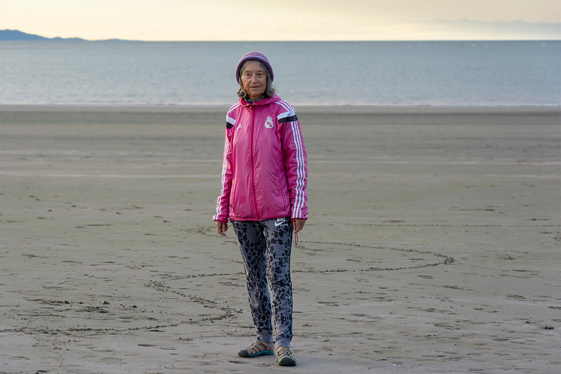 Thomas Slade - untitled 15, April 2020, Online exhibition: A Month of Sundays - Responses to the Covid-19 Lockdown, Photospace Gallery contemporary New Zealand photography, street portrait photography, environmental portrait photo, nelson new zealand, photography during covid-19 lockdown in New Zealand, woman in pink jacket on beach in Nelson