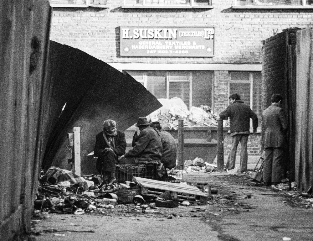 Photo by Brian de Montalk from East End '78 - Near Brick Lane (1), black and white film photos of the East End of London in 1978 at Photospace Gallery Wellington New Zealand September-October 2022, photo of hobos living rough in London in 1978