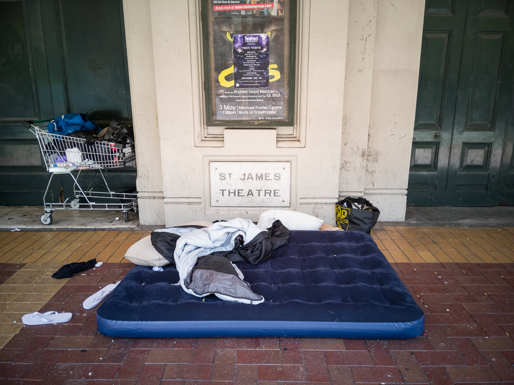 Photo: John Williams, from 'Nobody's Home' series, photos of homeless people's belongings on the streets of Wellington New Zealand, street photography, Photospace Gallery contemporary new Zealand photography gallery in Wellington Aotearoa NZ, contemporary urban documentary photography series, Necessary Distraction group exhibition at Photospace in June 2022, homeless person's possessions outside St James Theatre Wellington NZ