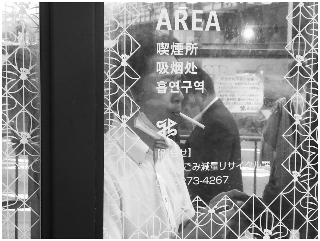 Photo: Pascal Harris, from 'Tokyo, July 4, 2023' series, analog photography, black and white film street photography, Tokyo street photography, social landscape photography, Photospace Gallery contemporary New Zealand Photography, street photo of man smoking cigarette in Tokyo