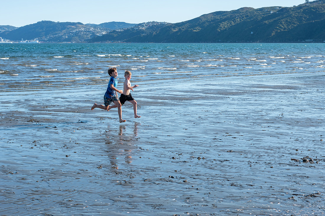 Peter Black - untitled 21, May 2020, A Month of Sundays - Responses to the Covid-19 Lockdown' online exhibition at PhotospaceGallery.nz, photography during covid-19 lockdown in New Zealand, two boys running on Petone beach during Alert Level 3 Petone New Zealand