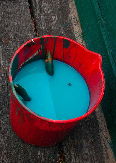 Photospace Gallery contemporary New Zealand photography, Wellington NZ, online exhibition covid-19 responses by new zealand photographic artists, tabletop photography, conceptual photography, red plastic bucket of blue paint