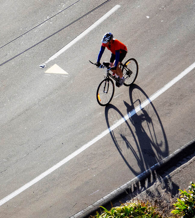 Nick Servian - 'untitled Wellington April 2020', cyclist and shadow,Online exhibition: A Month of Sundays - Responses to the Covid-19 Lockdown, Photospace Gallery contemporary New Zealand photography, wellington NZ, photography during covid-19 lockdown period in New Zealand